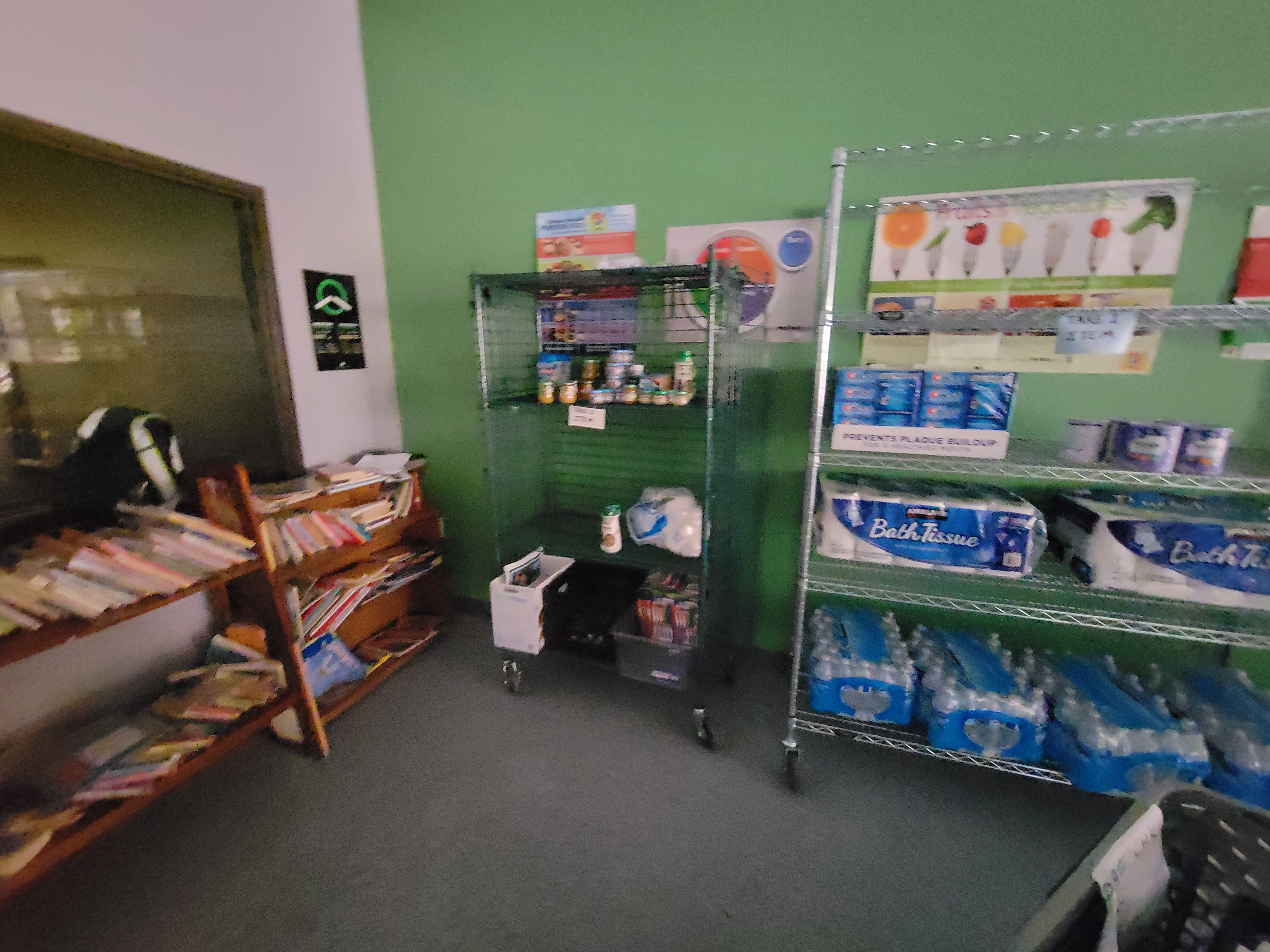 Different things on shelves next to a shelf of books on the left.
